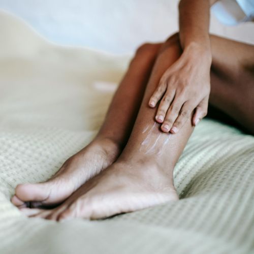 woman lotioning legs